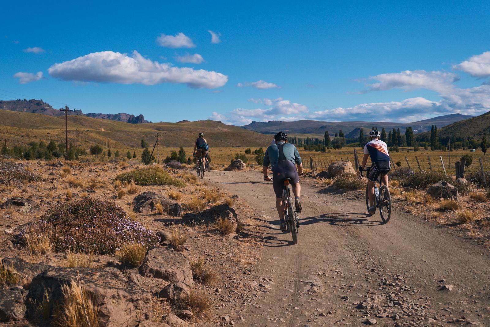 Three riders on a dirt road through the Patagonian steppe